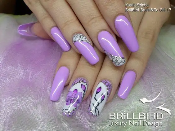 inspiração de unhas longas roxo claro com desenhos na cor branca