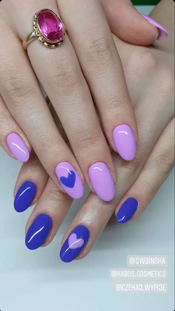 unhas pintadas de rosa e roxo com corações