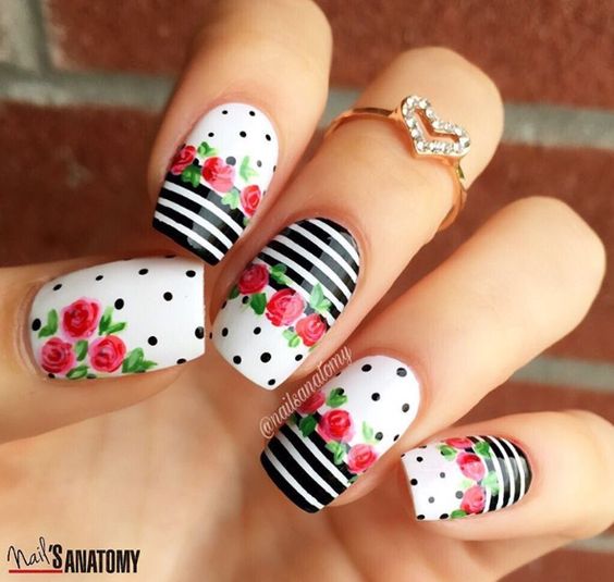 unhas estampadas com flores vermelhas e listras pretas