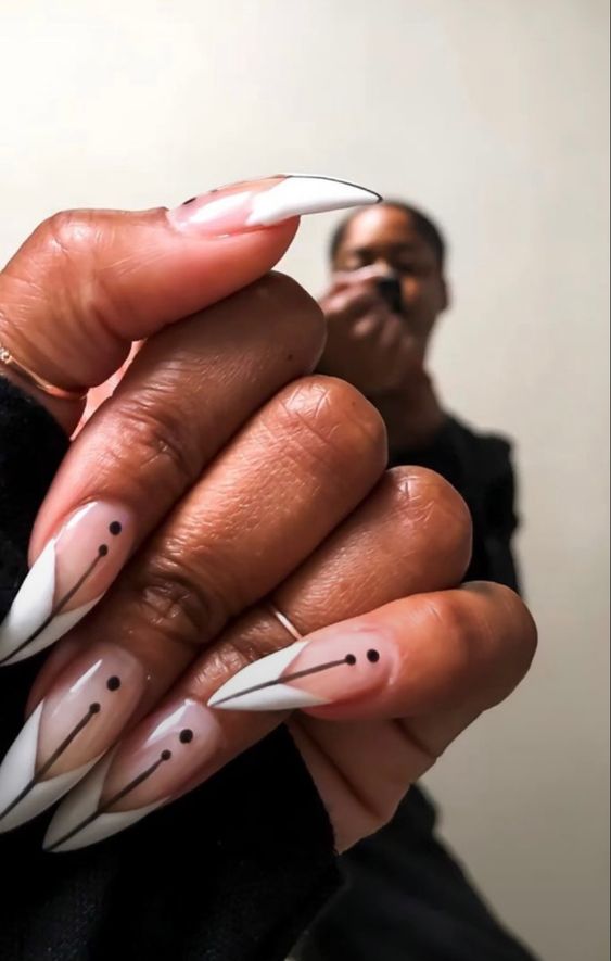 Francesinhas nas unhas pintadas de branco com detalhes pretos